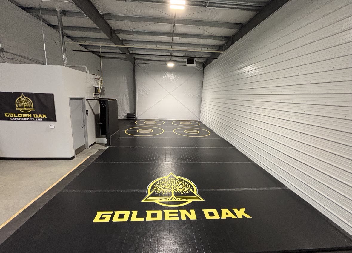 The clean, branded Golden Oak Combat Club training space at 4402 Weaver Ct in Hilliard