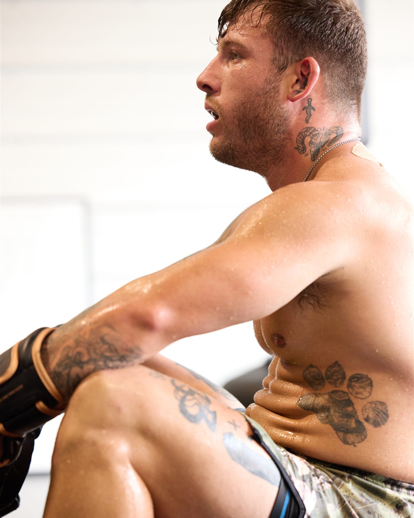 A member drenched in sweat catching his breath after a hard MMA training round